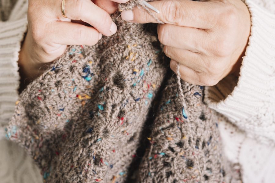 old-woman-light-sweater-knitting-scarf