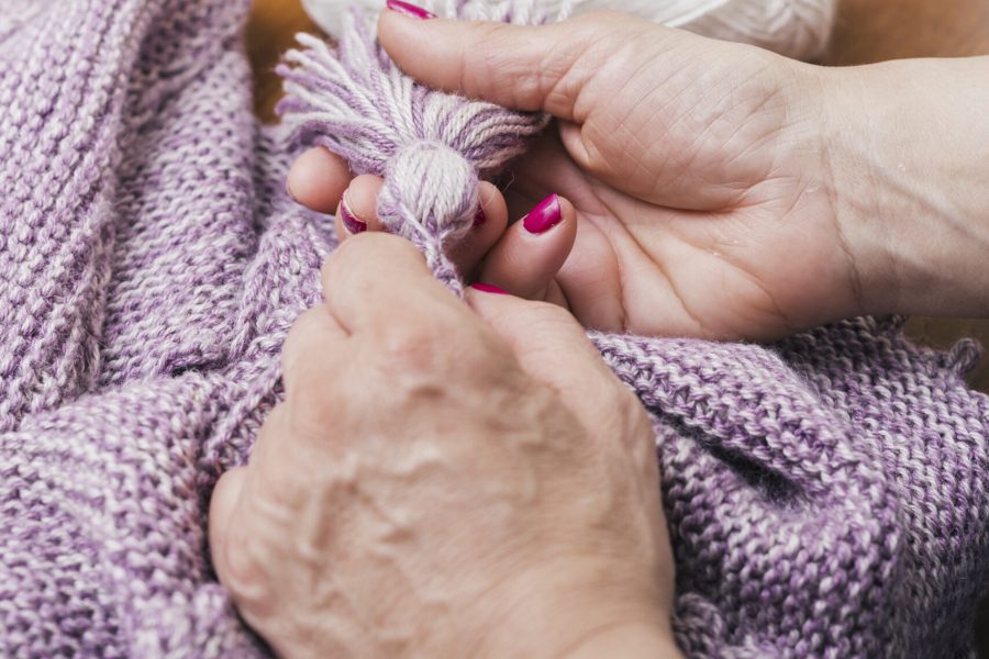 woman-s-hand-making-wool-tassel